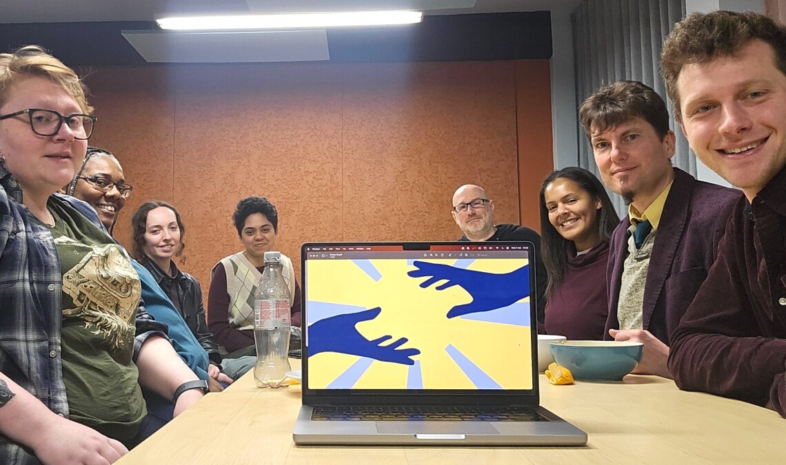 a group of people in discussion around a conference table