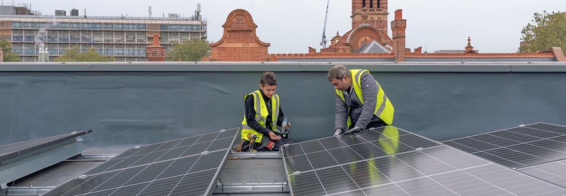 A member of the Repowering London team installing solar on a Newham rooftop